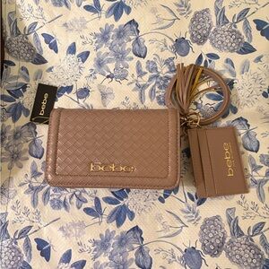 Bebe dusty rose detachable strap bag with wrist band as well snap close , zipper